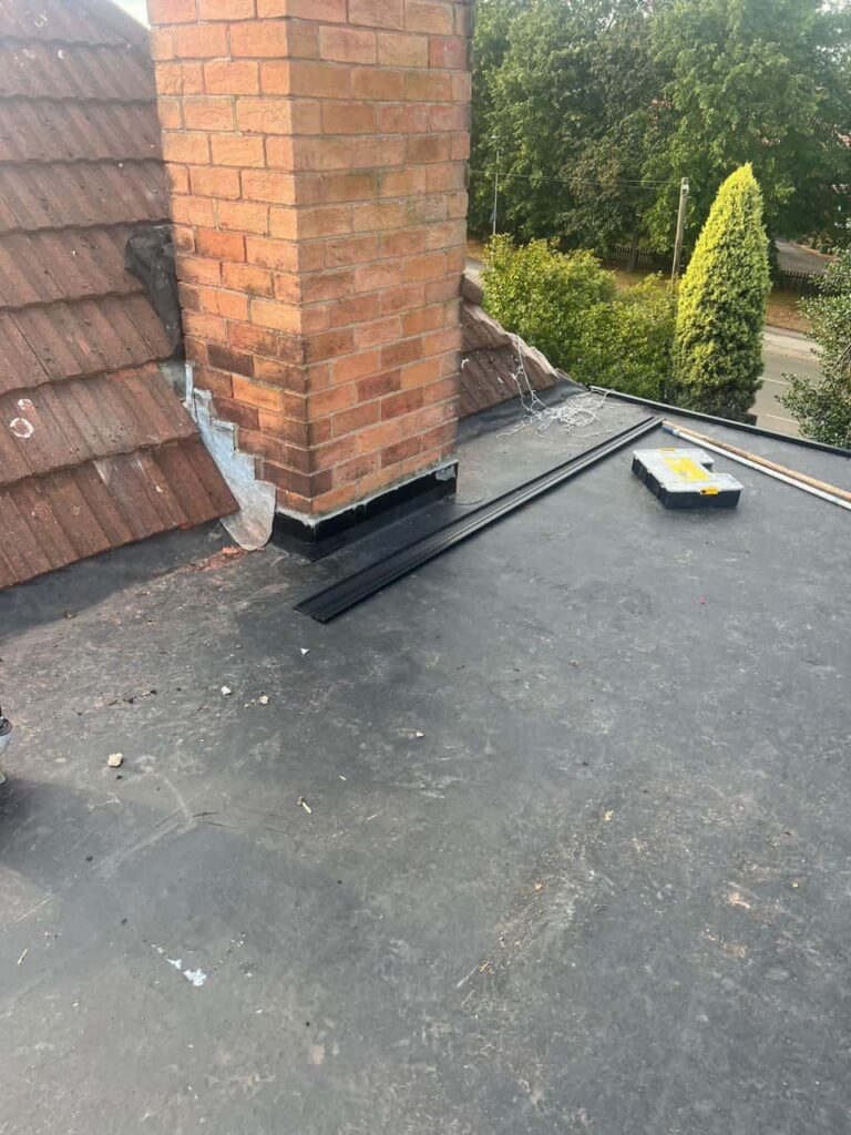 This is a photo of a flat roof which has just been repaired, there is also a chimney stack and some leadwork has also been dressed. Works carried out by Hassocks Roofing Repairs